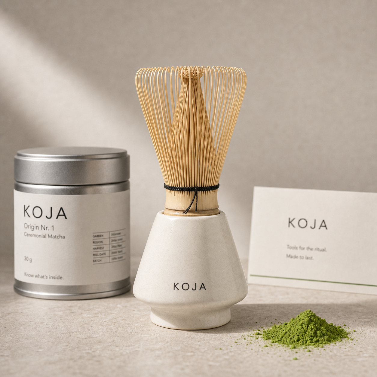 KOJA ceramic whisk holder with bamboo chasen, light premium matcha powder and silver KOJA tin